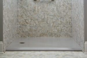 Gray barrier-free shower floor in bathroom for senior