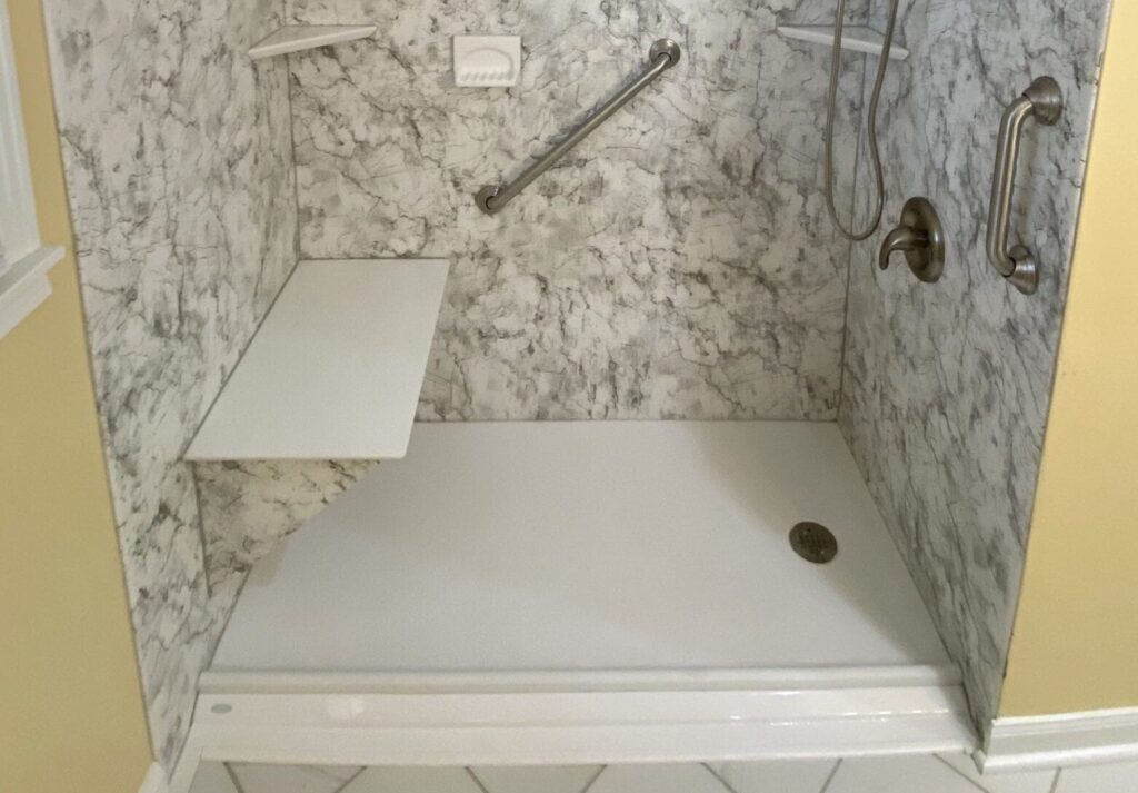 shower that is made as part of a handicap bathroom shower seat and grab bar