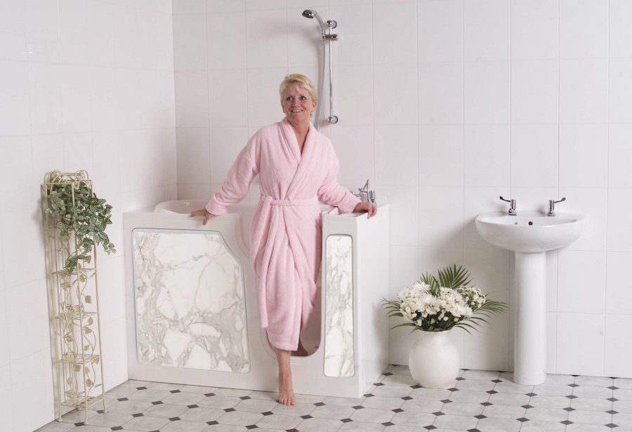 lady in pink robe getting out of a walk-in tub with Virbo jet massage system