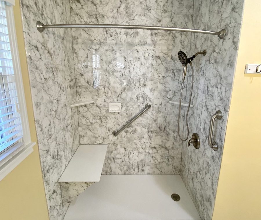 New bathroom shower with a shower bench